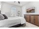 Cozy bedroom with a large window, mounted television, and dark wooden dresser at 22901 E Quintero Rd, Queen Creek, AZ 85142