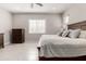 Bedroom featuring a large wooden bed frame, bedside tables, and tile flooring at 22901 E Quintero Rd, Queen Creek, AZ 85142