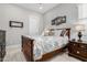 Cozy bedroom featuring a wooden bed frame, neutral walls, and stylish decor at 22901 E Quintero Rd, Queen Creek, AZ 85142