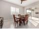 Cozy dining room with a wooden table, chairs, a ceiling fan, and sliding glass doors to the outside at 22901 E Quintero Rd, Queen Creek, AZ 85142