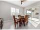 Sunlit dining room with a wooden table, chairs, and sliding door to the patio at 22901 E Quintero Rd, Queen Creek, AZ 85142