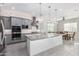 Bright, open kitchen featuring an island, gray cabinets, and stainless steel appliances at 22901 E Quintero Rd, Queen Creek, AZ 85142