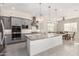 Stylish kitchen with gray cabinets, a large island with a granite countertop, and stainless steel appliances at 22901 E Quintero Rd, Queen Creek, AZ 85142