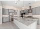 Beautiful kitchen featuring stainless steel appliances, gray cabinets, and a large island with a white base and granite counters at 22901 E Quintero Rd, Queen Creek, AZ 85142