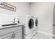 Well-equipped laundry room with modern washer and dryer at 22901 E Quintero Rd, Queen Creek, AZ 85142