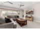 Comfortable living room with a plush sectional sofa, stylish decor, and a wooden entertainment center at 22901 E Quintero Rd, Queen Creek, AZ 85142