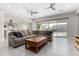 Open-concept living room with neutral tones, modern ceiling fans, and sliding glass doors at 22901 E Quintero Rd, Queen Creek, AZ 85142