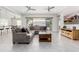 Open-concept living room with neutral tones, modern ceiling fans, and sliding glass doors at 22901 E Quintero Rd, Queen Creek, AZ 85142