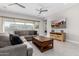 Bright living room featuring a cozy sectional sofa, modern ceiling fan, and a large window at 22901 E Quintero Rd, Queen Creek, AZ 85142