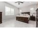 Serene main bedroom with a large bed, tile floors, and ample natural light at 22901 E Quintero Rd, Queen Creek, AZ 85142