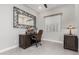 Charming office space featuring a dark wood desk, decorative mirror, and a comfortable leather chair at 22901 E Quintero Rd, Queen Creek, AZ 85142