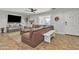 Living room with brown leather sectional sofa and ceiling fan at 2344 N Raven --, Mesa, AZ 85207