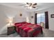 Charming bedroom with a ceiling fan and red and brown bedding at 23699 N Oasis Blvd, Florence, AZ 85132