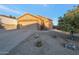 Front view of a charming house with a two-car garage and small front yard at 23699 N Oasis Blvd, Florence, AZ 85132