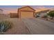 House exterior showcasing a two-car garage and drought-tolerant landscaping at 23699 N Oasis Blvd, Florence, AZ 85132