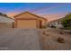 Single-story home with a two-car garage and desert landscaping at 23699 N Oasis Blvd, Florence, AZ 85132