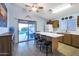 Kitchen with island seating, wood cabinets, and a view of the backyard at 23699 N Oasis Blvd, Florence, AZ 85132