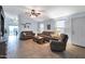 Spacious living area featuring tile floors, brown sofas, and a ceiling fan at 23699 N Oasis Blvd, Florence, AZ 85132