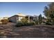 Single-story home with desert landscaping and covered patio at 26175 W Firehawk Dr, Buckeye, AZ 85396