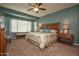 Relaxing bedroom with ceiling fan and large window at 26175 W Firehawk Dr, Buckeye, AZ 85396