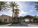 Community entrance with covered walkway and lush landscaping at 26175 W Firehawk Dr, Buckeye, AZ 85396