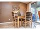 Small dining area with light wood table and chairs at 26175 W Firehawk Dr, Buckeye, AZ 85396