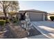 Single-story home with gray exterior, two-car garage, and desert landscaping at 26175 W Firehawk Dr, Buckeye, AZ 85396