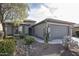 One-story home with gray exterior, two-car garage, and desert landscaping at 26175 W Firehawk Dr, Buckeye, AZ 85396