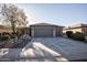 Single story home with gray exterior, two-car garage, and desert landscaping at 26175 W Firehawk Dr, Buckeye, AZ 85396