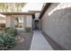 Front entrance of the home with gray stucco exterior and walkway at 26175 W Firehawk Dr, Buckeye, AZ 85396