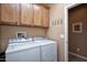 Bright laundry room with cabinets and an additional room at 26175 W Firehawk Dr, Buckeye, AZ 85396