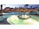 Large community pool and spa with lighting at night at 26175 W Firehawk Dr, Buckeye, AZ 85396