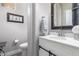 Elegant bathroom with a white vanity and industrial-style mirror at 2626 E Bear Creek Ln, Phoenix, AZ 85024