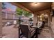 Relaxing covered patio offers comfortable seating, a TV, and views of the pool at 2626 E Bear Creek Ln, Phoenix, AZ 85024