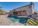 Spacious backyard with private pool, covered patio, and lush desert landscaping at 2848 E Menlo St, Mesa, AZ 85213