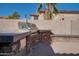 Backyard patio featuring a built-in grill and desert landscaping at 2848 E Menlo St, Mesa, AZ 85213