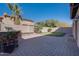 Backyard patio featuring a built-in grill, grassy area and desert landscaping at 2848 E Menlo St, Mesa, AZ 85213