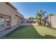 Relaxing backyard featuring putting green, built-in barbecue, and desert landscaping at 2848 E Menlo St, Mesa, AZ 85213