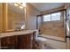 Classic bathroom features vanity with granite countertop and a tub with tile surround at 2848 E Menlo St, Mesa, AZ 85213