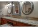 Double vanity bathroom with granite countertop and ornate mirrors at 2848 E Menlo St, Mesa, AZ 85213