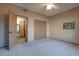 Bedroom featuring neutral carpet, ceiling fan and double closet at 2848 E Menlo St, Mesa, AZ 85213