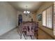 Formal dining room with tile flooring, a chandelier, and views into the kitchen at 2848 E Menlo St, Mesa, AZ 85213