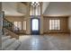 Grand foyer featuring soaring ceilings, tile floors, shuttered windows, and an ornate wrought iron door at 2848 E Menlo St, Mesa, AZ 85213