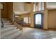 Entryway displaying tile floors, staircase, and natural light from the custom front door at 2848 E Menlo St, Mesa, AZ 85213