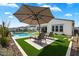 Relaxing pool area with lounge chairs and umbrella at 3015 E Daley Ln, Phoenix, AZ 85050