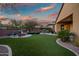 Spacious backyard featuring a fire pit and grassy area at 30224 N 52Nd Pl, Cave Creek, AZ 85331