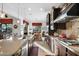 Long kitchen island with sink and a view into the breakfast nook at 30224 N 52Nd Pl, Cave Creek, AZ 85331