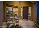 Charming courtyard entry with tiled flooring, metal table and chairs, and lush flowers at 30224 N 52Nd Pl, Cave Creek, AZ 85331