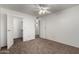 Spacious bedroom with mirrored closet doors and ceiling fan at 3511 E Baseline Rd # 1210, Phoenix, AZ 85042