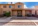 Two-story stucco condo with double-door entry and desert landscaping at 3511 E Baseline Rd # 1210, Phoenix, AZ 85042